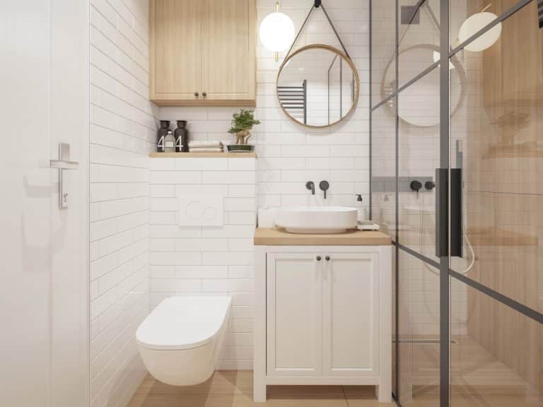 bathroom with tiled wall and cabinet