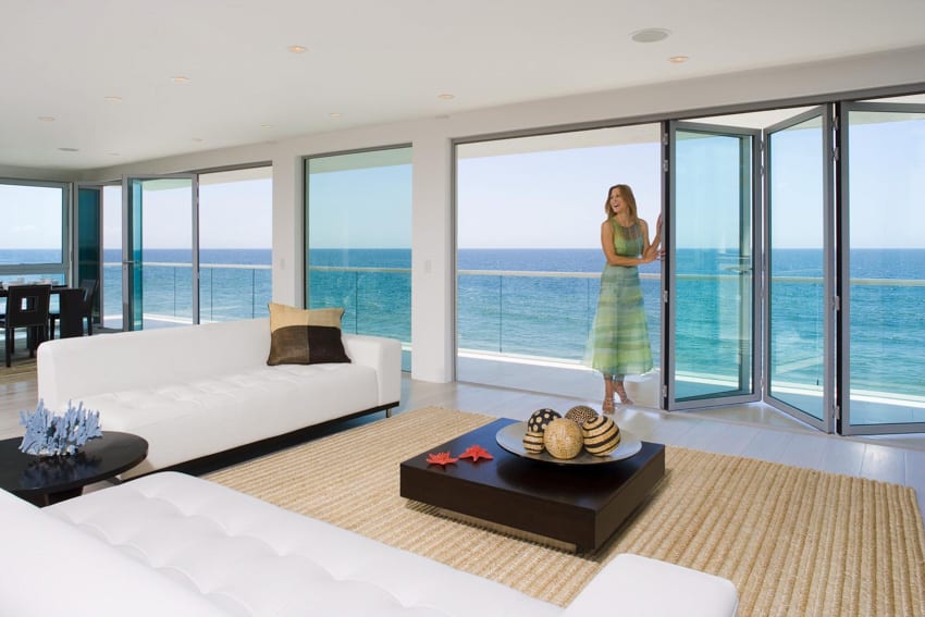 Folding glass door wood floor white sofa chairs coffee table