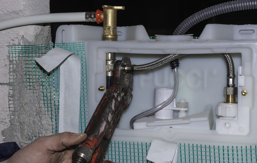 Plumber mounting a wall dual flush