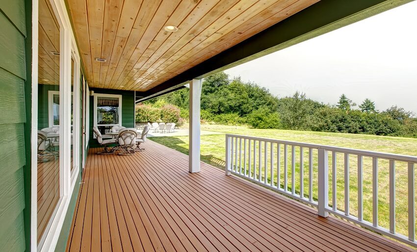 Spacious veranda with table set and wood ceiling